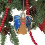 Christmas angel ornament, handmade, hardwood, hanging from red ribbon.