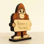 Angled view of layered hardwood emotional support bigfoot showing wood species detail and construction