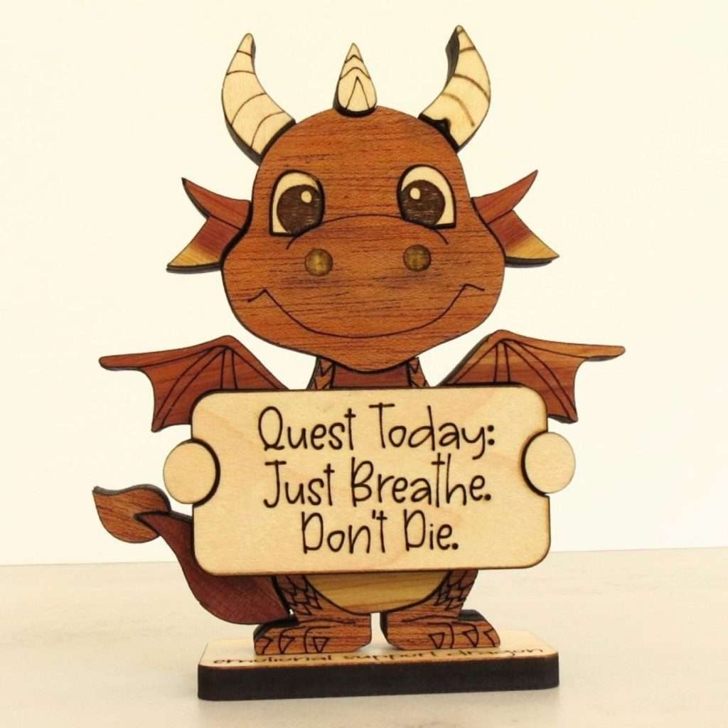 Handcrafted hardwood emotional support dragon desk pet holding sign that reads Quest Today Just Breathe Don't Die