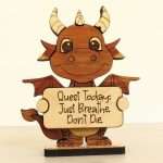 Handcrafted hardwood emotional support dragon desk pet holding sign that reads Quest Today Just Breathe Don't Die