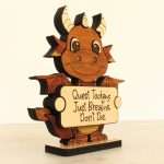 Side view of layered hardwood emotional support dragon showing wood species detail and base depth.