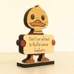 Angled view of layered hardwood emotional support duck showing wood species detail and construction