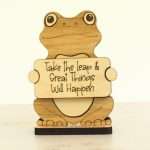 Handcrafted hardwood emotional support frog desk pet holding sign that reads Take the Leap and Great Things Will Happen