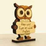 Angled view of layered hardwood emotional support owl showing wood species detail and construction