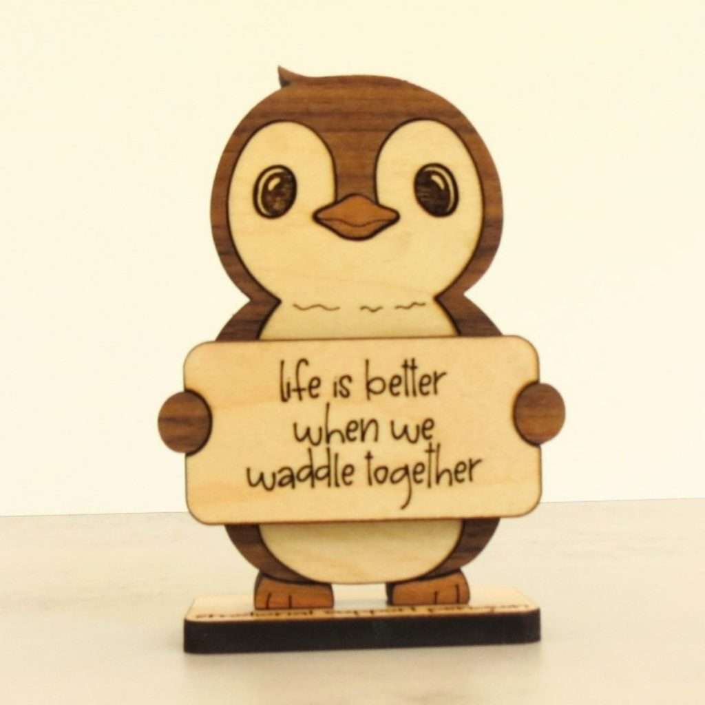 Angled view of layered hardwood emotional support penguin showing wood species detail and construction
