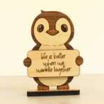 Angled view of layered hardwood emotional support penguin showing wood species detail and construction