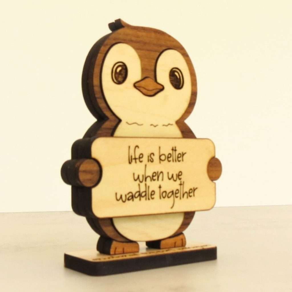 Handcrafted hardwood emotional support penguin desk pet holding sign that reads Life Is Better When We Waddle Together