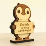 Handcrafted hardwood emotional support penguin desk pet holding sign that reads Life Is Better When We Waddle Together