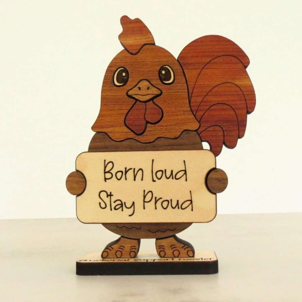 Handcrafted hardwood emotional support rooster desk pet holding sign that reads Born Loud Stay Proud