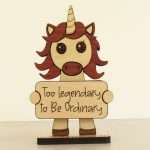 Handcrafted hardwood emotional support unicorn desk pet holding sign that reads Too Legendary to Be Ordinary
